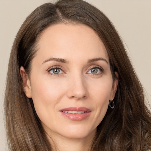 Joyful white young-adult female with long  brown hair and grey eyes