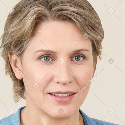 Joyful white adult female with medium  brown hair and blue eyes