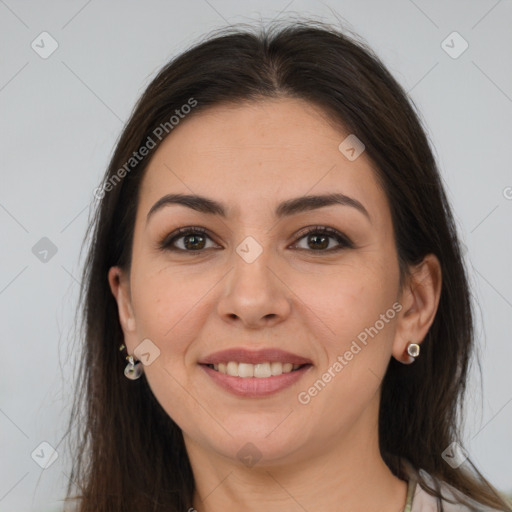 Joyful white adult female with long  brown hair and brown eyes