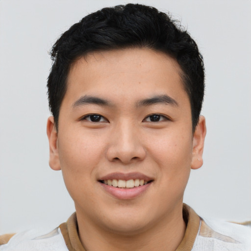 Joyful asian young-adult male with short  brown hair and brown eyes