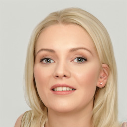 Joyful white young-adult female with long  brown hair and blue eyes