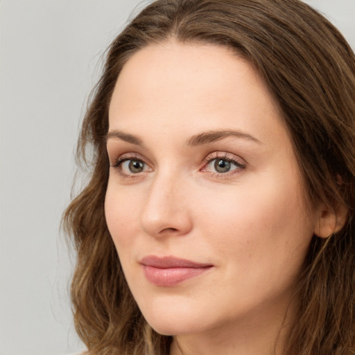 Neutral white young-adult female with long  brown hair and green eyes