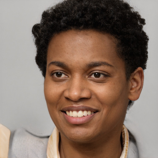 Joyful black young-adult female with short  brown hair and brown eyes