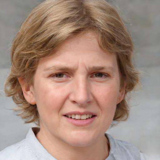 Joyful white young-adult female with medium  brown hair and blue eyes