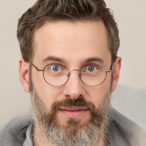 Joyful white adult male with short  brown hair and grey eyes