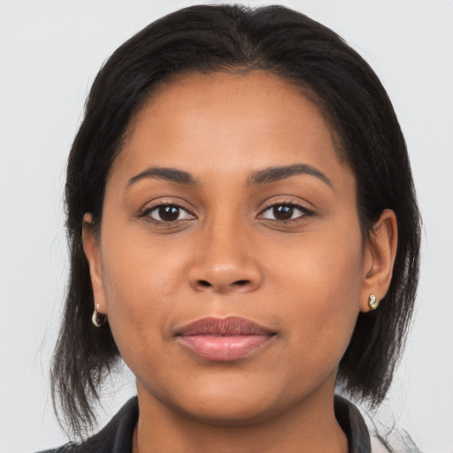 Joyful latino young-adult female with medium  brown hair and brown eyes