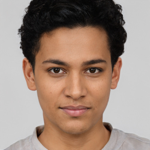 Joyful latino young-adult male with short  brown hair and brown eyes