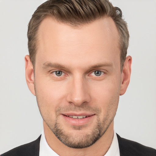 Joyful white young-adult male with short  brown hair and brown eyes