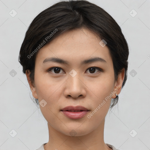 Joyful asian young-adult female with short  black hair and brown eyes