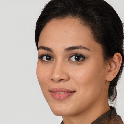 Joyful latino young-adult female with medium  brown hair and brown eyes