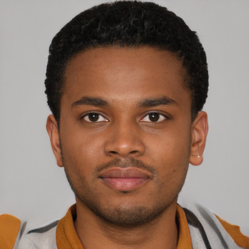 Joyful latino young-adult male with short  brown hair and brown eyes
