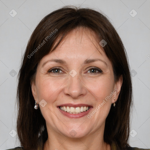 Joyful white adult female with medium  brown hair and grey eyes