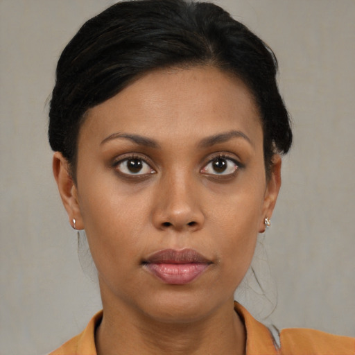 Joyful black young-adult female with short  brown hair and brown eyes