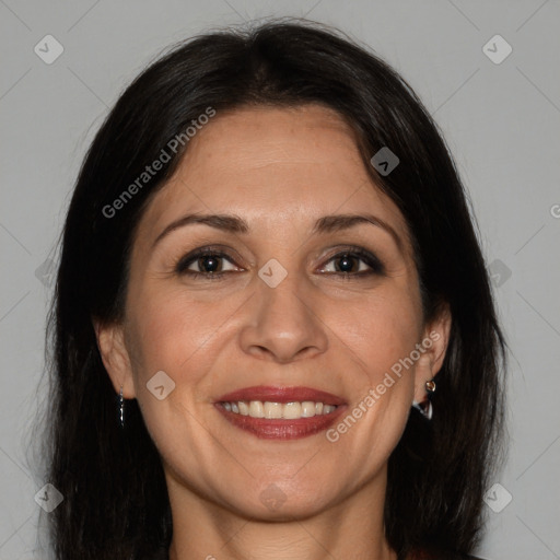 Joyful white adult female with long  brown hair and brown eyes