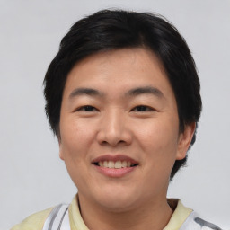 Joyful asian young-adult male with short  black hair and brown eyes