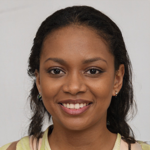 Joyful black young-adult female with medium  brown hair and brown eyes