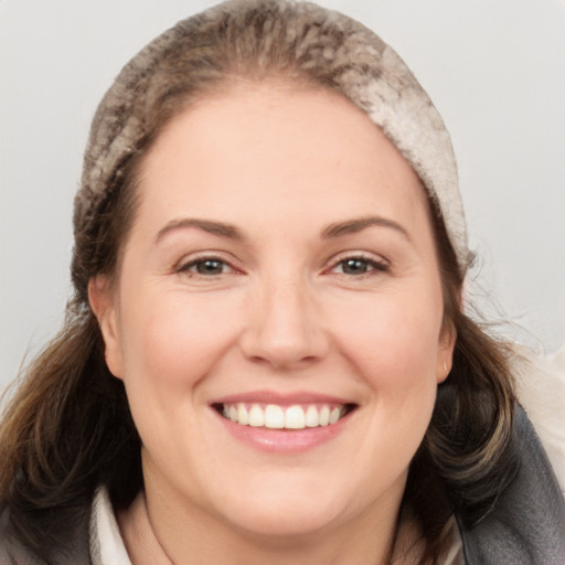 Joyful white adult female with long  brown hair and brown eyes