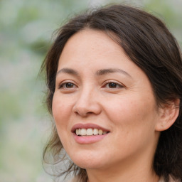 Joyful white adult female with medium  brown hair and brown eyes