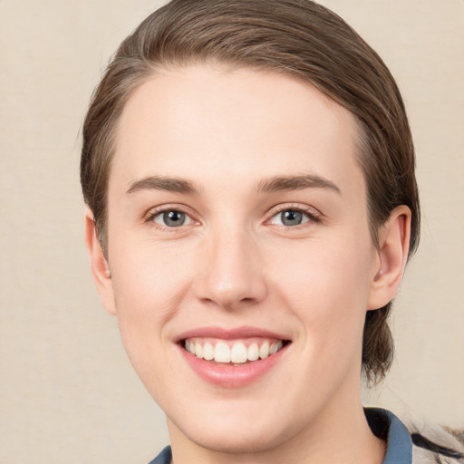 Joyful white young-adult female with medium  brown hair and green eyes