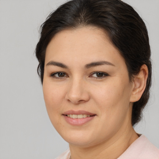 Joyful asian young-adult female with medium  brown hair and brown eyes
