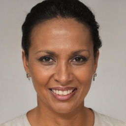 Joyful black adult female with short  brown hair and brown eyes