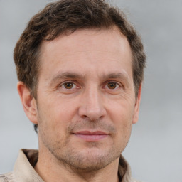 Joyful white adult male with short  brown hair and grey eyes