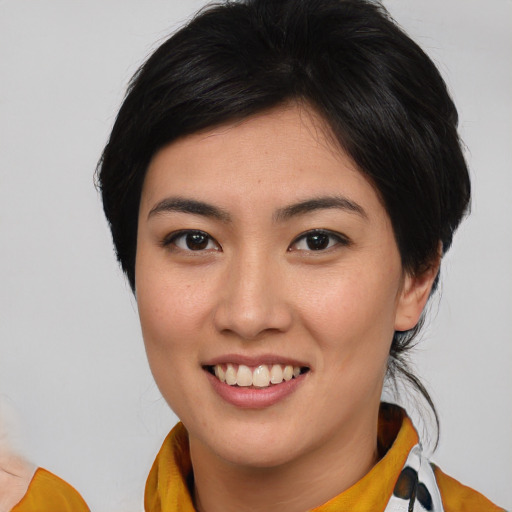 Joyful asian young-adult female with medium  brown hair and brown eyes