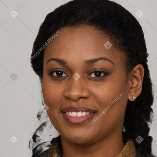 Joyful black young-adult female with long  black hair and brown eyes