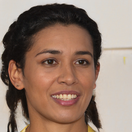 Joyful latino young-adult female with medium  brown hair and brown eyes