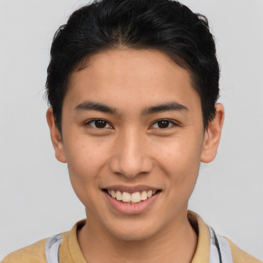 Joyful latino young-adult male with short  brown hair and brown eyes