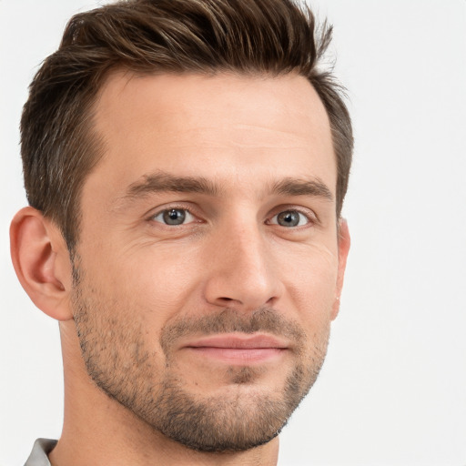 Joyful white young-adult male with short  brown hair and grey eyes