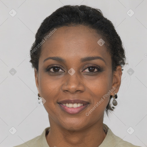 Joyful black young-adult female with short  black hair and brown eyes