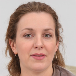 Joyful white adult female with medium  brown hair and grey eyes