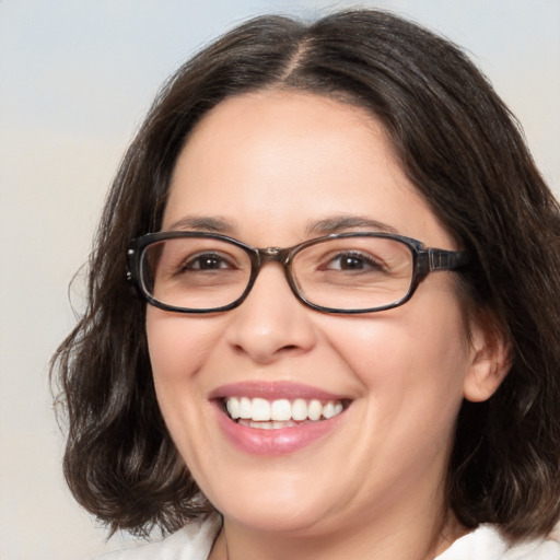 Joyful white adult female with medium  brown hair and brown eyes