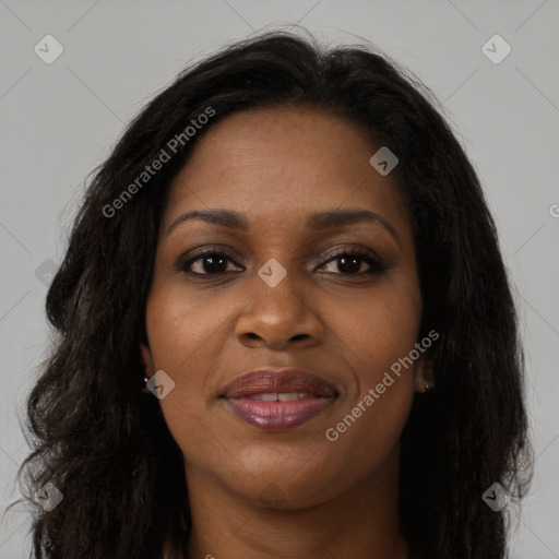 Joyful black young-adult female with long  brown hair and brown eyes