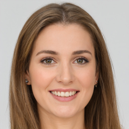 Joyful white young-adult female with long  brown hair and green eyes