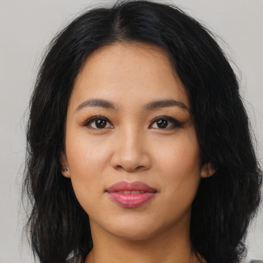Joyful latino young-adult female with long  black hair and brown eyes