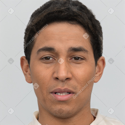 Joyful latino young-adult male with short  brown hair and brown eyes