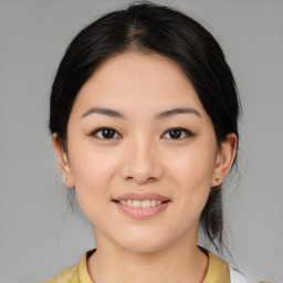 Joyful asian young-adult female with medium  brown hair and brown eyes