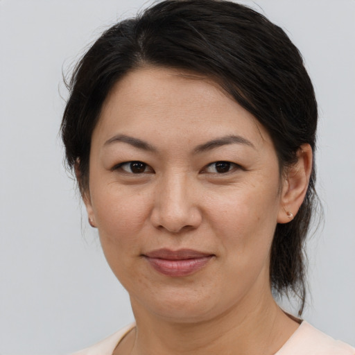 Joyful white adult female with medium  brown hair and brown eyes
