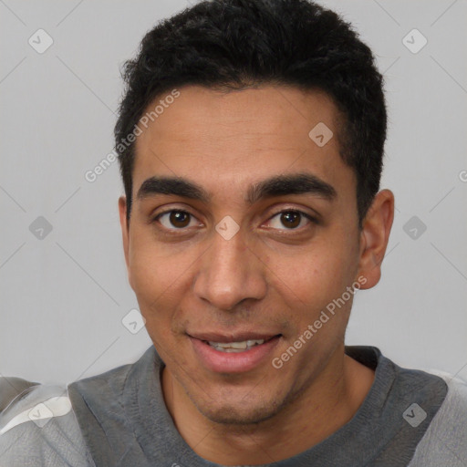 Joyful white young-adult male with short  black hair and brown eyes