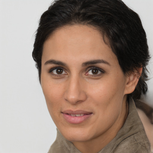 Joyful latino young-adult female with short  brown hair and brown eyes