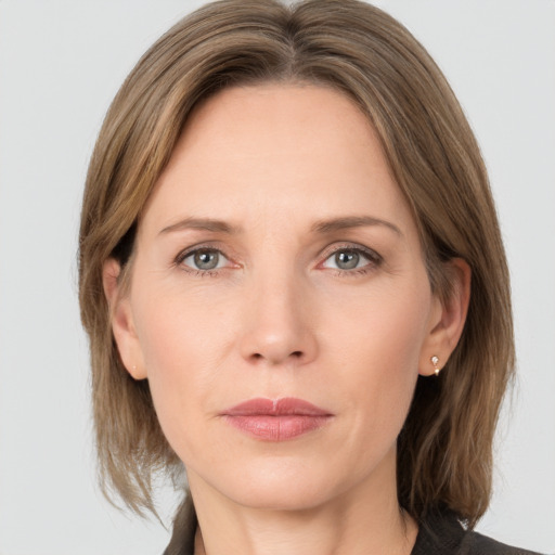 Joyful white adult female with medium  brown hair and grey eyes