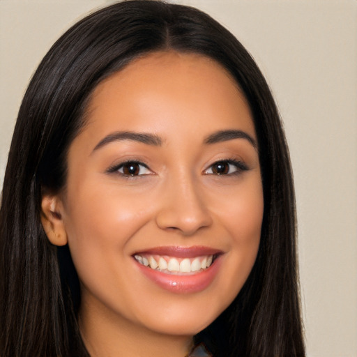 Joyful latino young-adult female with long  brown hair and brown eyes