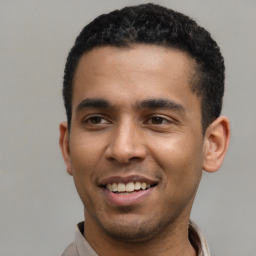 Joyful latino young-adult male with short  black hair and brown eyes