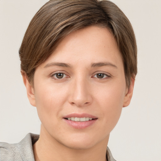 Joyful white young-adult female with short  brown hair and grey eyes