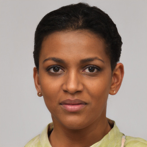 Joyful black young-adult female with short  black hair and brown eyes