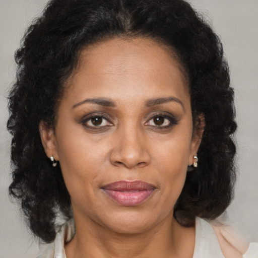 Joyful latino adult female with medium  brown hair and brown eyes