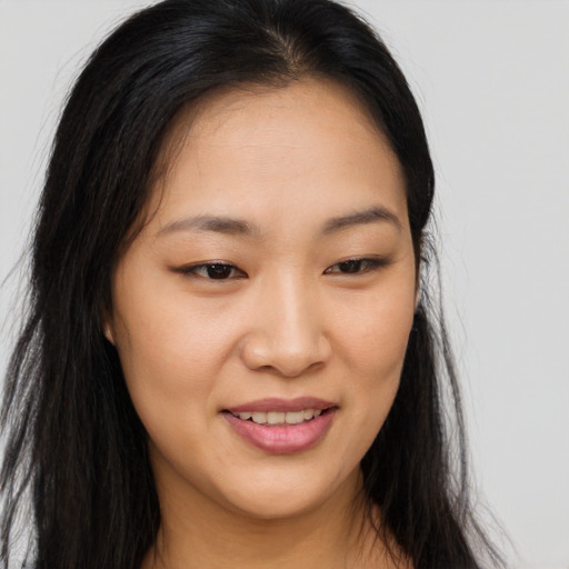 Joyful asian young-adult female with long  brown hair and brown eyes