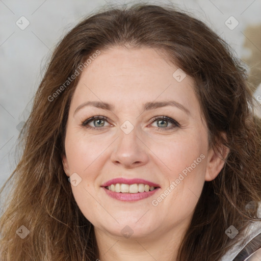 Joyful white adult female with long  brown hair and grey eyes